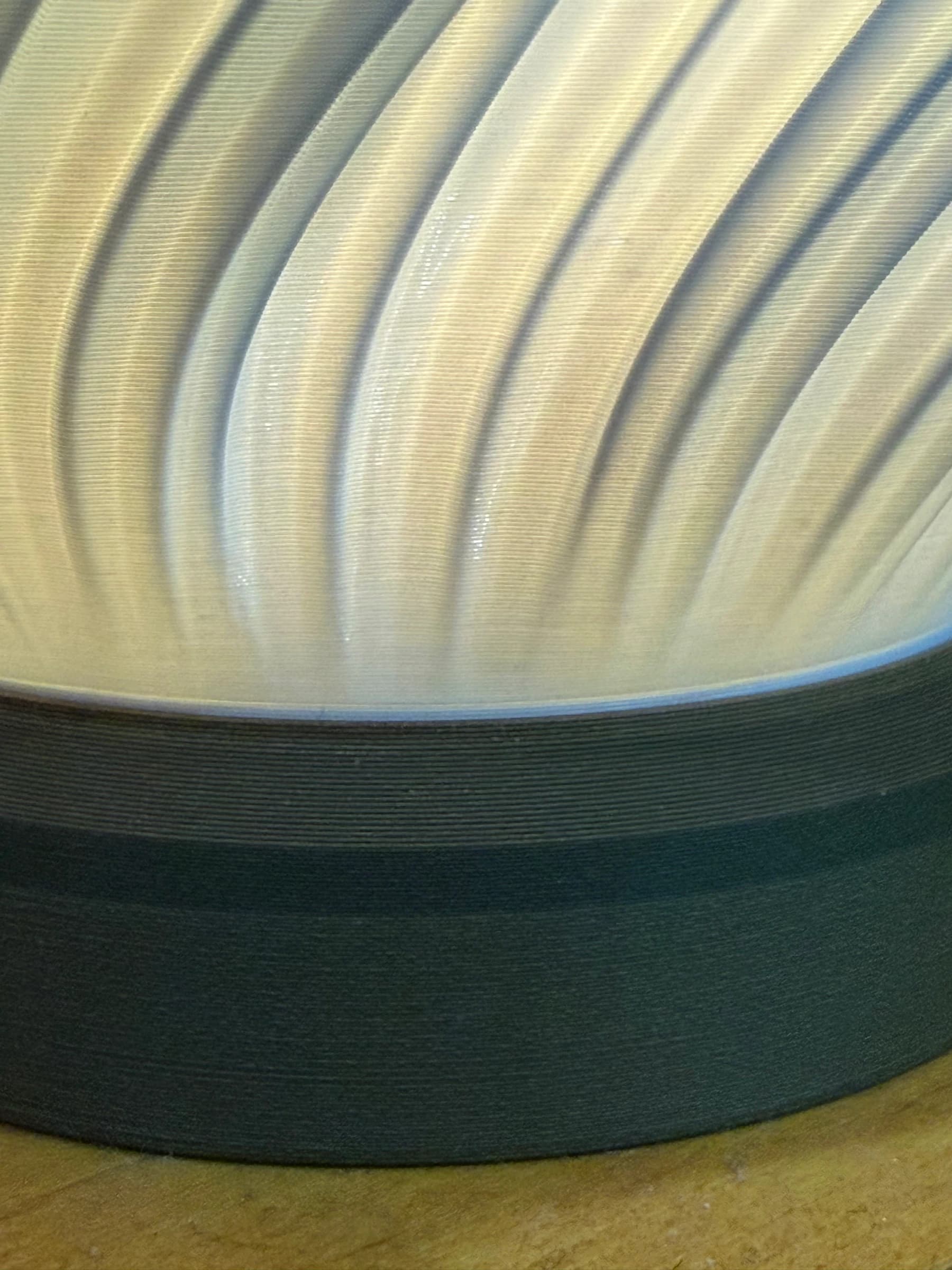 Close-up of the walnut base and the spiral ridges of the shade