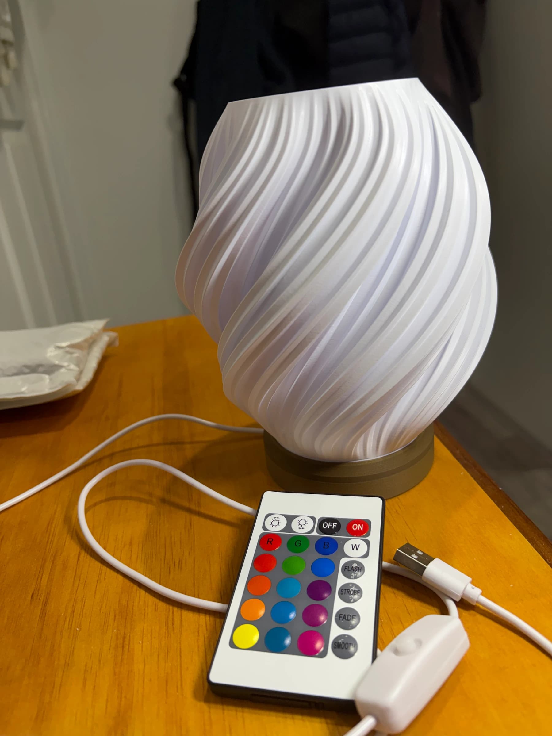 The lamp switched off, with the remote and the inline cable switch beside it