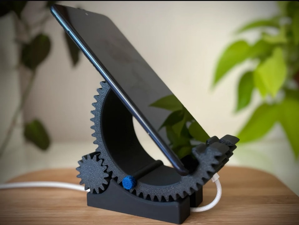 CogForm holding a phone while a charging cable passes through the base